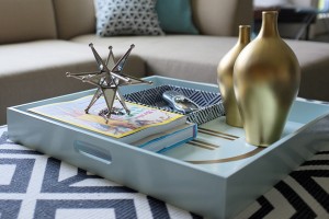 Well-styled tray placed on ottoman