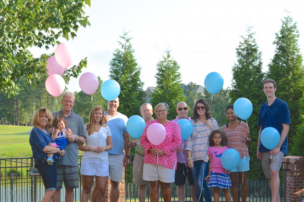 Our families holding balloons indicating their gender guesses!