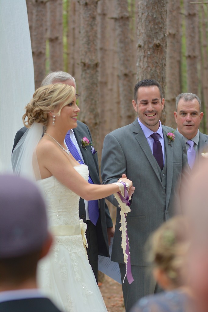 The bride and groom engaged in traditional Handfasting...